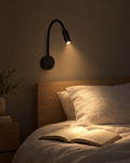 Fiume matte black gooseneck reading light drawn as a thin line against a dark panelled wall