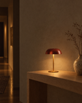 Fungo oxide red cordless mushroom lamp standing alone on a dark wood table