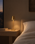 Cono small brass touch lamp on a nightstand corner beside a clock and a glass of water