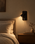 Duo matte black bedside wall light with ambient wash and a swivelling reading spot above a bed